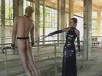 Madam in latex spanking slave dude